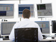 Photodune 316693 stock trader looking at multiple monitors xs